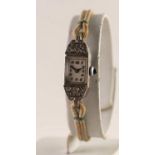 1950's WHITE METAL PASTE SET LADY'S WRISTWATCH with blue stone set winding button and Arabic dial,