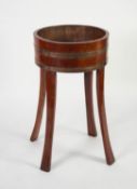 EARLY TWENTIETH CENTURY BRASS BANDED AND COOPERED MAHOGANY STAINED PLANTER, of shallow, circular