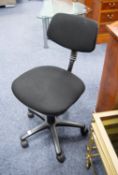 A TYPIST'S REVOLVING OFFICE CHAIR, the back and covered in black cloth, on five spur base with