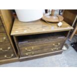 AN ELM TELEVISION STAND WITH OPEN COMPARTMENT AND TWO DRAWERS BELOW WITH BRASS DROP HANDLES, ON