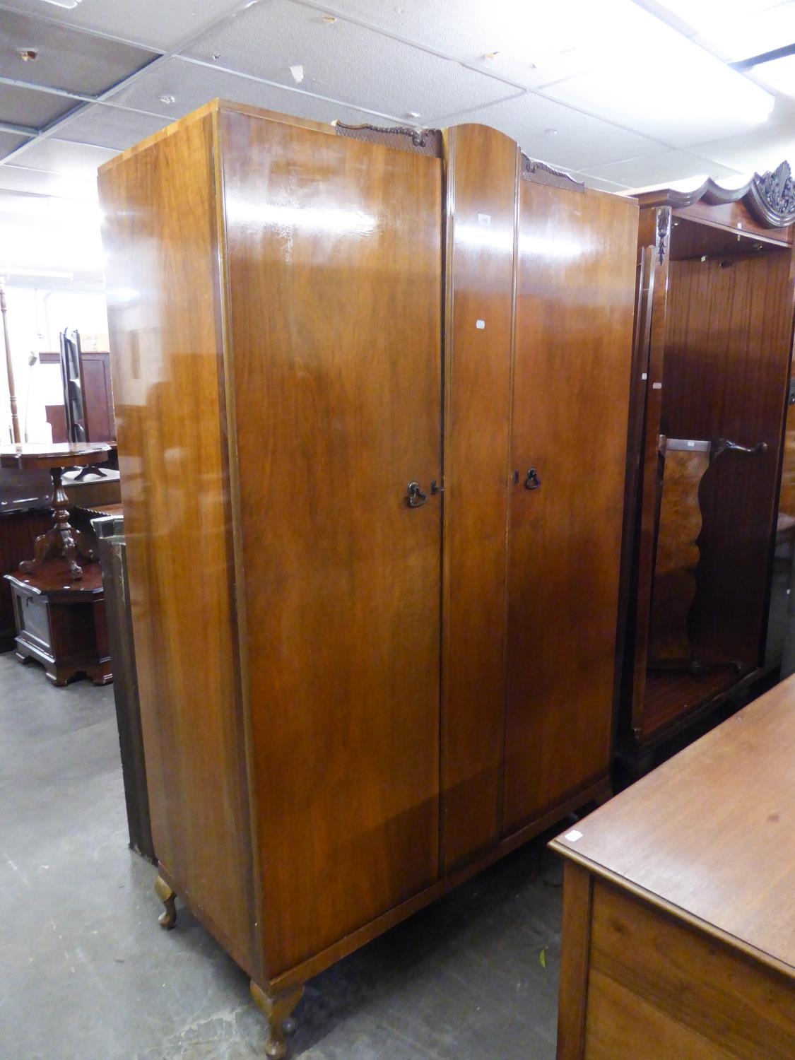 A QUEEN ANNE STYLE DOUBLE DOOR WARDROBE, RAISED ON SMALL CABRIOLE FEET
