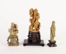 THREE CHINESE CARVED GREEN SOAPSTONE FIGURES, comprising: one modelled as a SAGE, carrying fish,