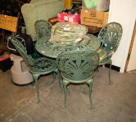 A GREEN COLOURED METAL REPRODUCTION LIGHTWEIGHT CIRCULAR GARDEN TABLE AND FOUR MATCHING CHAIRS