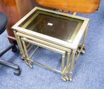 NEST OF THREE OBLONG COFFEE  TABLES, with satin brass framed smoked glass tops, gilt brass fluted