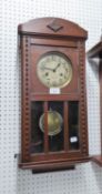 OAK CASED FRAMED VIENNA WALL CLOCK, HAVING BRASS DIAL WITH KEY AND PENDULUM