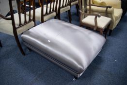 DURESTA LARGE RECTANGULAR FOOTSTOOL, upholstered and covered in steel grey silk fabric on four black