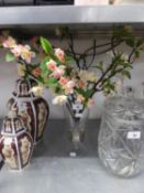 A GLASS URN SHAPED VASE WITH SILK APPLE BLOSSOM FLOWERS