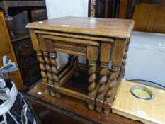 A NEST OF THREE OAK COFFEE TABLES, RAISED ON BARLEY TWIST SUPPORTS