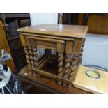 A NEST OF THREE OAK COFFEE TABLES, RAISED ON BARLEY TWIST SUPPORTS