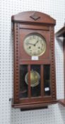 OAK CASED  WELLINGTON WALL CLOCK, HAVING BRASS DIAL WITH KEY AND PENDULUM