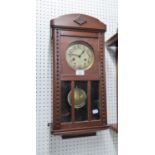 OAK CASED  WELLINGTON WALL CLOCK, HAVING BRASS DIAL WITH KEY AND PENDULUM