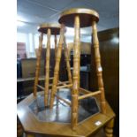 A PAIR OF HARDWOOD TALL KITCHEN STOOLS WITH CIRCULAR PANEL SEATS