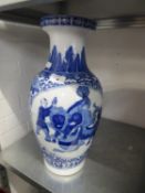 TWENTIETH CENTURY ORIENTAL BLUE AND WHITE PORCELAIN LARGE VASE, painted with figures and temple