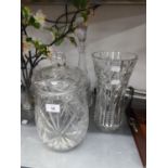 A HEAVY CUT GLASS LARGE WAISTED FLOWER VASE, 12? HIGH; A TALL CUT GLASS CAMPANA SHAPED DECANTER