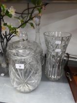 A HEAVY CUT GLASS LARGE WAISTED FLOWER VASE, 12? HIGH; A TALL CUT GLASS CAMPANA SHAPED DECANTER