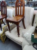 A WINGED FIRESIDE ARMCHAIR COVERED IN BEIGE WOVEN FABRIC, ON STUMP CABRIOLE SUPPORTS