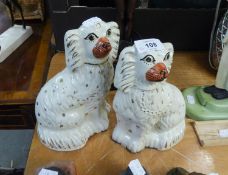 A PAIR OF 19TH CENTURY STAFFORDSHIRE POTTERY MANTEL DOGS