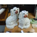 A PAIR OF 19TH CENTURY STAFFORDSHIRE POTTERY MANTEL DOGS