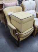 A MODERN ALL-UPHOLSTERED FIRESIDE ARMCHAIR AND SQUARE BOX STOOL ENSUITE, COVERED IN BUTTONED BEIGE