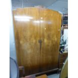 A WALNUTWOOD TWO DOOR WARDROBE; AN OAK MILLINERY CABINET, WITH TWO DOORS OVER TWO DRAWERS AND