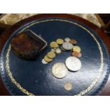 A PURSE CONTAINING AN AMERICAN 1879 MORGAN SILVER DOLLAR; AN ELIZABETH II 1977 CROWN COIN AND