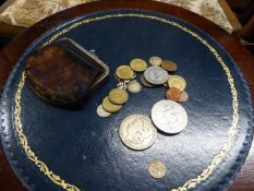 A PURSE CONTAINING AN AMERICAN 1879 MORGAN SILVER DOLLAR; AN ELIZABETH II 1977 CROWN COIN AND