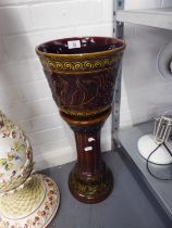 A BROWN GLAZED POTTERY JARDINIERE, ON LOW PEDESTAL STAND