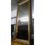 A TALL, BEVELLED EDGE OBLONG ROBING MIRROR, IN GILT FRAME