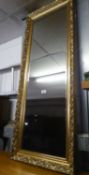 A TALL, BEVELLED EDGE OBLONG ROBING MIRROR, IN GILT FRAME