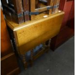 A SMALL OAK DROP LEAF TABLE