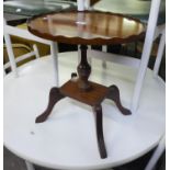 A MAHOGANY REGENCY STYLE OVAL COFFEE TABLE, ON QUARTETTE SUPPORTS