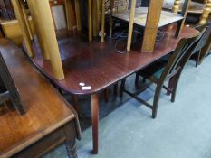 A MAHOGANY EXTENDING DINING TABLE, WITH FOLDING LEAF BELOW