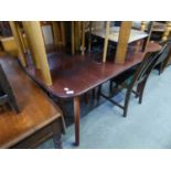 A MAHOGANY EXTENDING DINING TABLE, WITH FOLDING LEAF BELOW