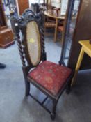 A SET OF FOUR OAK DINING CHAIRS, WITH CANE DECORATION TO THE BACKS, RAISED ON BARLEY TWIST FRONT