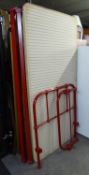 AN ANTIQUE HEAVY RED METAL HOSPITAL SINGLE BED WITH BASE