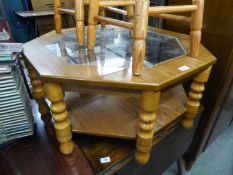 A TEAK OCTAGONAL COFFEE TABLE WITH INSET GLASS TOP AND UNDERSHELF AND A NEST OF THREE COFFEE TABLES