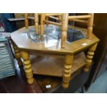 A TEAK OCTAGONAL COFFEE TABLE WITH INSET GLASS TOP AND UNDERSHELF AND A NEST OF THREE COFFEE TABLES