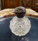 EDWARDIAN CUT GLASS GLOBULAR PERFUME BOTTLE WITH SCROLL EMBOSSED SILVER SCREW-OFF TOP, BIRMINGHAM