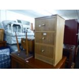 AN OAK BEDSIDE CHEST OF THREE DRAWERS, 1960S OBLONG COFFEE TABLE AND A FOOTSTOOL/WORK BOX WITH TWO