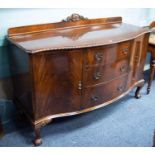 CHIPPENDALE REVIVAL MAHOGANY SERPENTINE SIDEBOARD, with low ledge back, three graduated centre