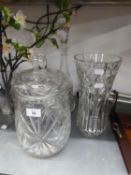 A HEAVY CUT GLASS LARGE WAISTED FLOWER VASE, 12? HIGH; A TALL CUT GLASS CAMPANA SHAPED DECANTER