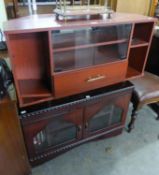 A MAHOGANY TELEVISION STAND WITH TWO GLAZED DOORS, GADROON CARVED EDGES AND ANOTHER SIMILAR TV STAND