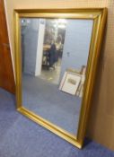 A LARGE GILT FRAMED BEVELLED EDGE WALL MIRROR (139cm high x 108cm wide) (frame a.f.)