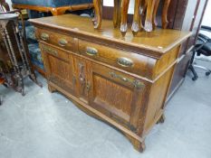 A LARGE OAK ARTS AND CRAFTS SIDEBOARD, HAVING TWO DRAWERS OVER TWO PANEL CUPBOARD DOORS (LACKING