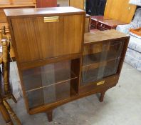 1970?S TEAK COMBINED STEP-TOPPED COCKTAIL CABINET WITH FALL FRONT, MIRROR LINED AND FITTED