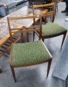 A SET OF FOUR 1970's TEAK DINING CHAIRS WITH LADDER RAIL BACKS, PADDED SEATS, SQUARE TAPERING