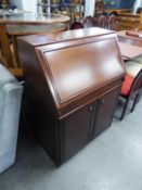 A REPRODUCTION MAHOGANY BUREAU WITH FALL-FRONT OVER TWO CUPBOARDS (107cm HIGH X 83cm WIDE x 46cm