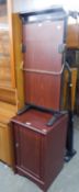 A PAIR OF MAHOGANY EFFECT MODERN BEDSIDE CUPBOARDS AND A ?STRIDES? ELECTRIC VALET STAND (3)