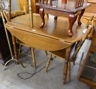 A SET OF THREE HARDWOOD SINGLE CHAIRS AND A FALL-LEAF CIRCULAR DINING TABLE