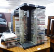 A GOOD SELECTION OF CD's IN REVOLVING TABLE TOP STAND